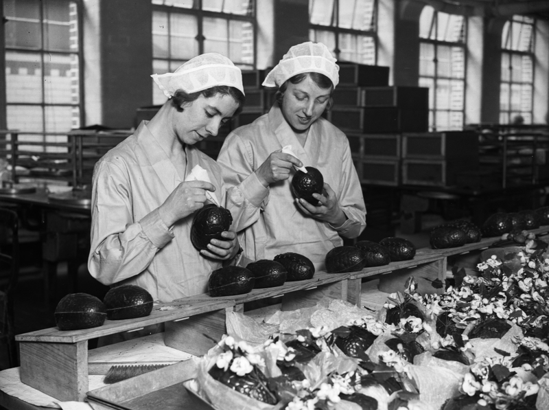 Two women at the Cadbury’s chocolate factory in Bournville, in the West Midlands join together chocolate Easter egg halves in 1932.